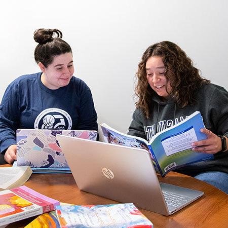 Immaculata University Learning Support Services - two female students at desk studying with laptops